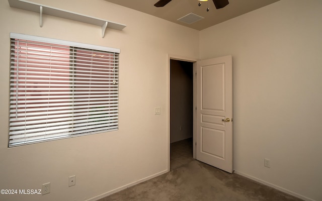 carpeted empty room featuring ceiling fan