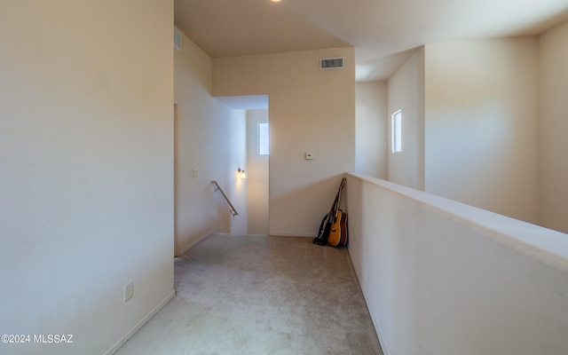 hall featuring light colored carpet