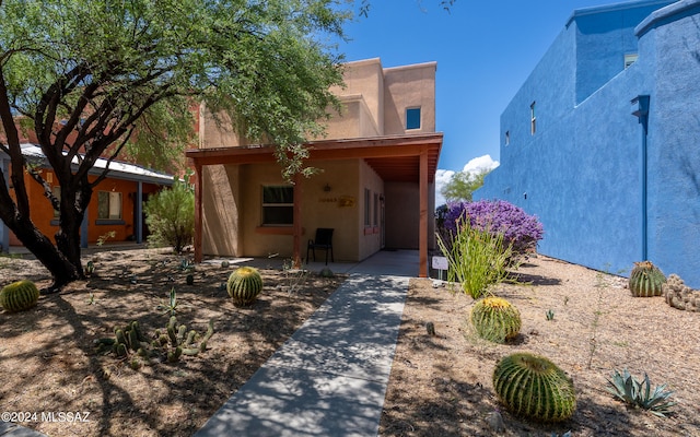 pueblo revival-style home featuring a carport