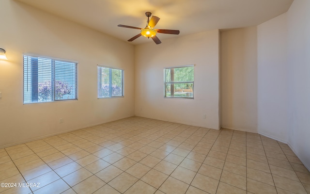 tiled empty room with ceiling fan