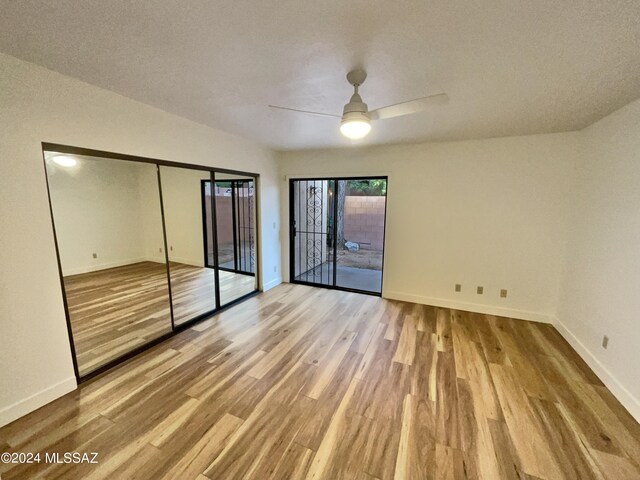 unfurnished bedroom featuring a closet, light wood-type flooring, and a textured ceiling