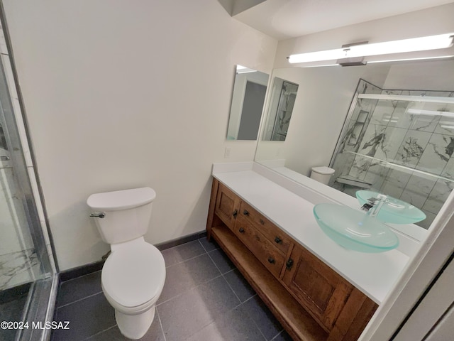 bathroom featuring vanity, a shower with shower door, toilet, and tile patterned flooring