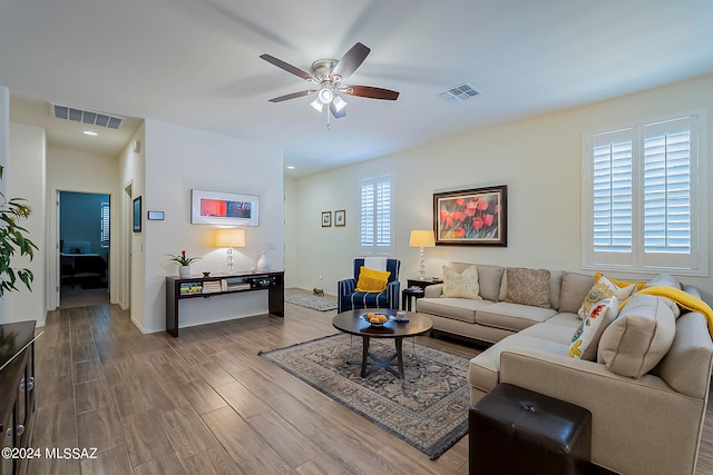 living room featuring hardwood / wood-style flooring and ceiling fan