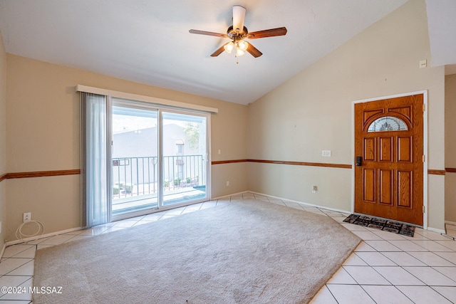 entryway featuring ceiling fan, light colored carpet, and high vaulted ceiling