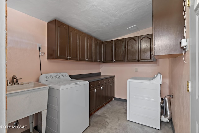 washroom with washer / dryer, a sink, and cabinet space
