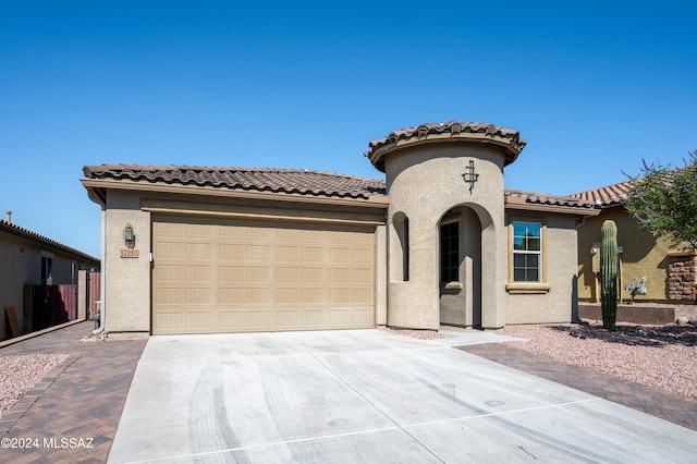 mediterranean / spanish house featuring a garage