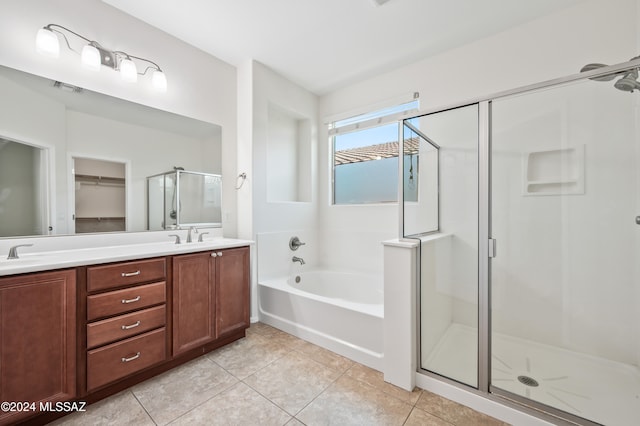 bathroom with tile patterned flooring, vanity, and shower with separate bathtub