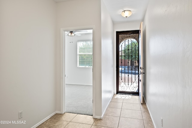 foyer featuring ceiling fan and light tile patterned flooring