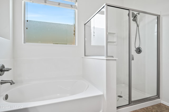 bathroom with tile patterned floors and independent shower and bath