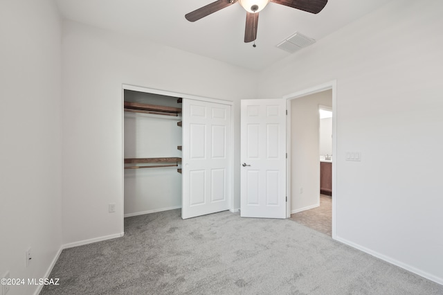 unfurnished bedroom with a closet, ceiling fan, and light colored carpet