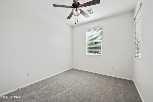 spare room featuring carpet flooring and ceiling fan