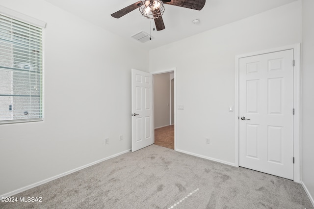 unfurnished bedroom featuring ceiling fan and light colored carpet