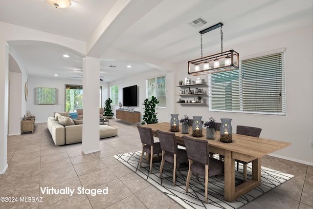 dining space with light tile patterned floors and ceiling fan