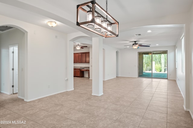 unfurnished living room featuring light tile patterned floors and ceiling fan