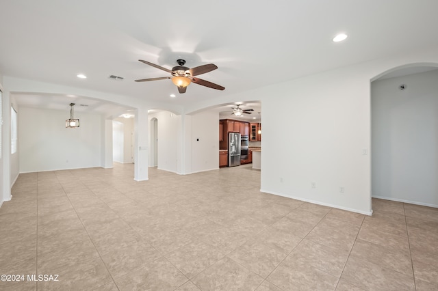 unfurnished living room with ceiling fan and light tile patterned flooring