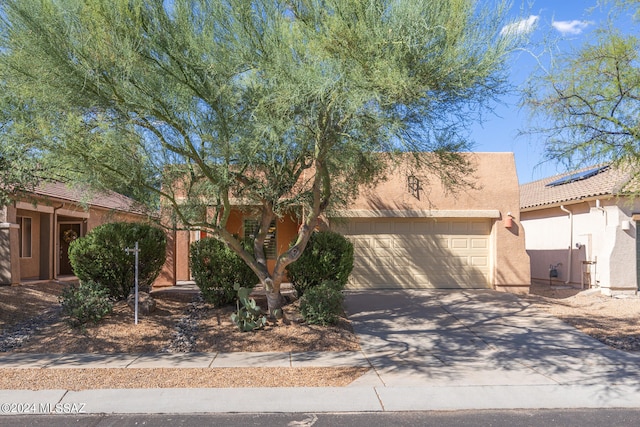 pueblo-style home with a garage