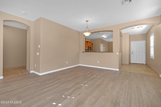 unfurnished living room featuring light wood-type flooring