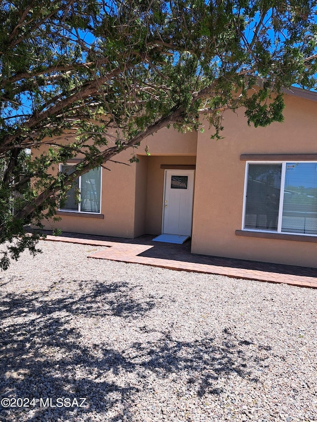 property entrance with stucco siding