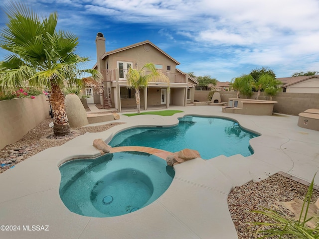 view of swimming pool featuring an in ground hot tub and a patio area