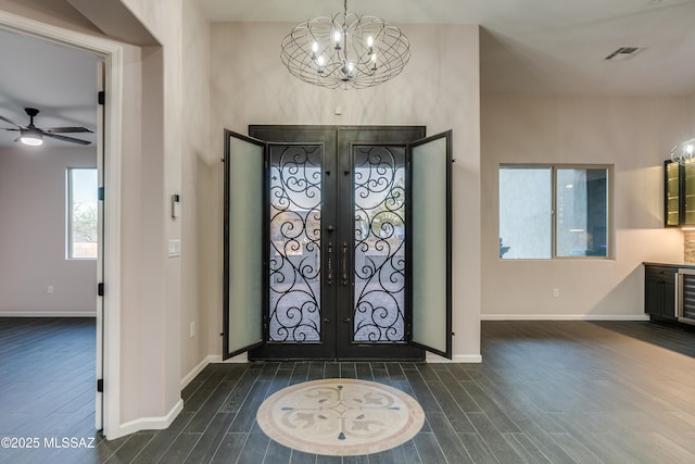 2102 N Corte El Rancho Merlita, Tucson, AZ 85715 - foyer entrance with french doors, a chandelier, dark wood-style flooring, and baseboards