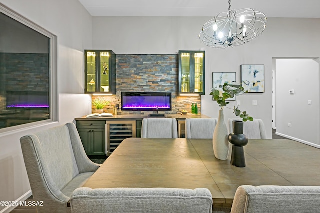 2102 N Corte El Rancho Merlita, Tucson, AZ 85715 - dining room featuring wine cooler, a glass covered fireplace, and a chandelier