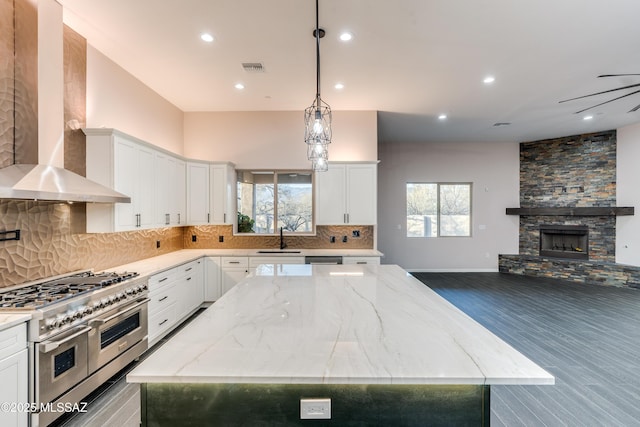 2102 N Corte El Rancho Merlita, Tucson, AZ 85715 - kitchen featuring stainless steel appliances, a sink, wall chimney range hood, a kitchen island, and tasteful backsplash