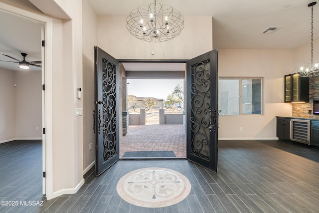 2102 N Corte El Rancho Merlita, Tucson, AZ 85715 - foyer entrance with a chandelier, beverage cooler, dark wood-style floors, and baseboards