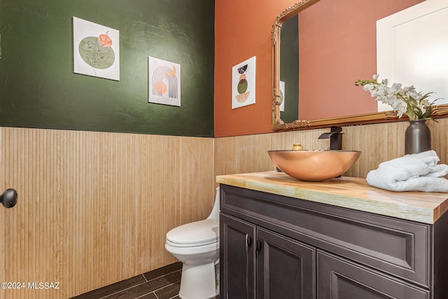 2102 N Corte El Rancho Merlita, Tucson, AZ 85715 - half bath with vanity, toilet, wood finish floors, and a wainscoted wall