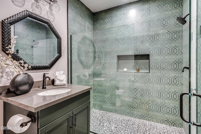 bathroom featuring vanity and an enclosed shower