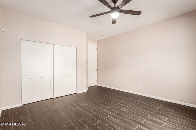 unfurnished bedroom with ceiling fan, dark hardwood / wood-style flooring, and a closet