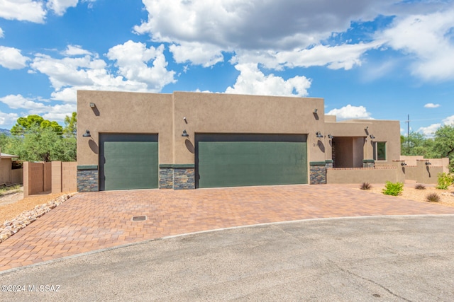 pueblo-style house featuring a garage