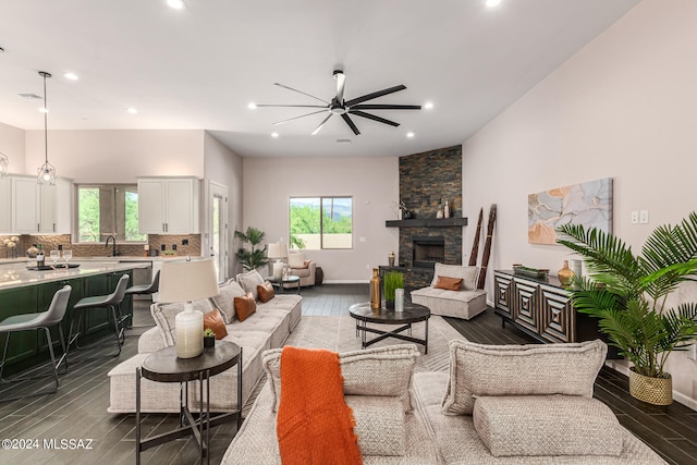 living room with dark wood-type flooring, a fireplace, and plenty of natural light