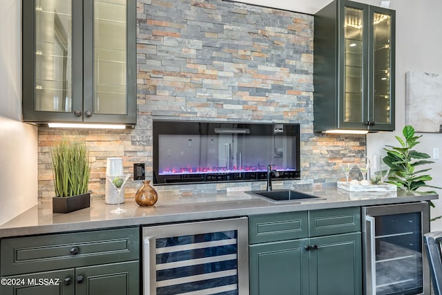 bar featuring wine cooler, sink, light stone counters, and backsplash