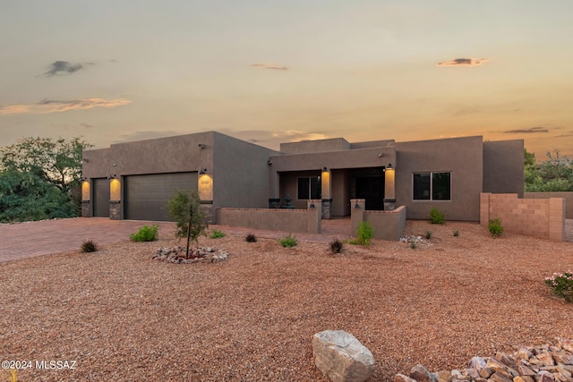 2102 N Corte El Rancho Merlita, Tucson, AZ 85715 - pueblo-style home featuring an attached garage, stucco siding, and decorative driveway