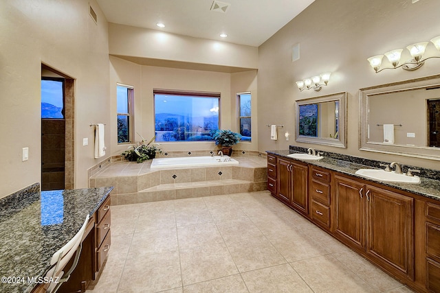 bathroom with tile patterned floors, shower with separate bathtub, and vanity