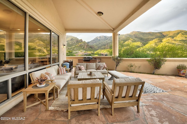 view of patio with an outdoor living space and a mountain view