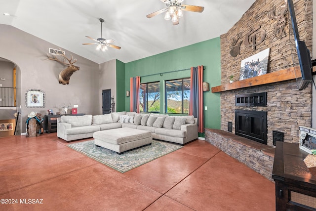 living room featuring arched walkways, a fireplace, visible vents, a ceiling fan, and finished concrete flooring