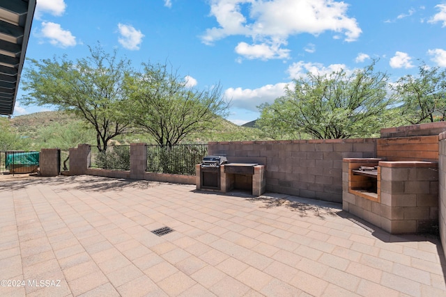 view of patio / terrace featuring a grill and fence