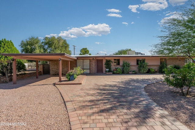 ranch-style house featuring a carport