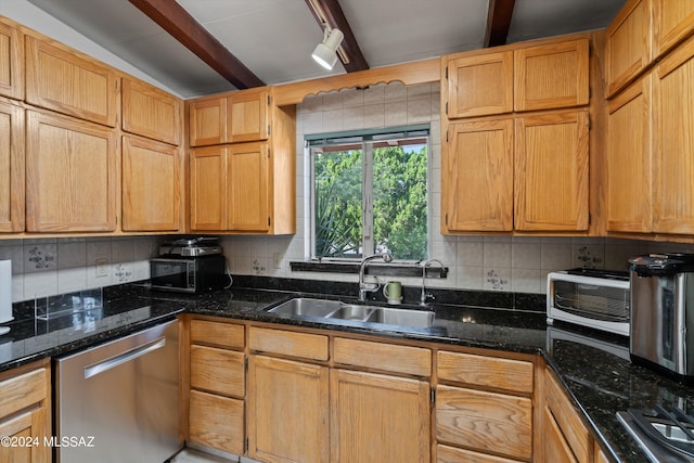 kitchen with decorative backsplash, dark stone countertops, stainless steel appliances, beam ceiling, and sink