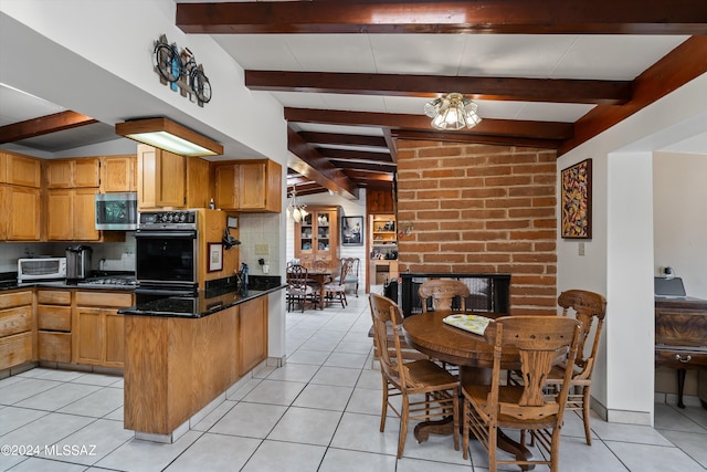 kitchen with beam ceiling, a chandelier, appliances with stainless steel finishes, and backsplash