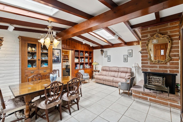 tiled dining room featuring vaulted ceiling with beams, an inviting chandelier, and a fireplace