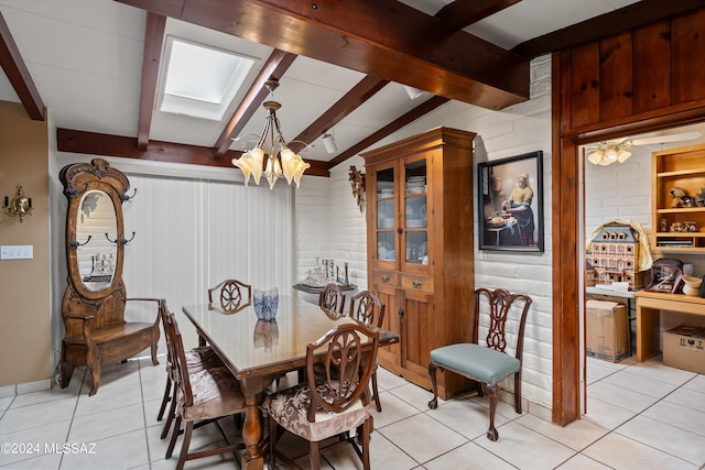 dining space featuring a chandelier, brick wall, lofted ceiling with skylight, and light tile patterned floors