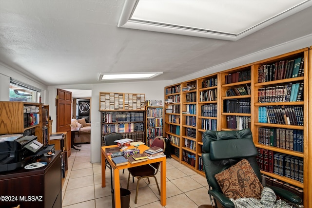 interior space with stacked washing maching and dryer and light tile patterned flooring