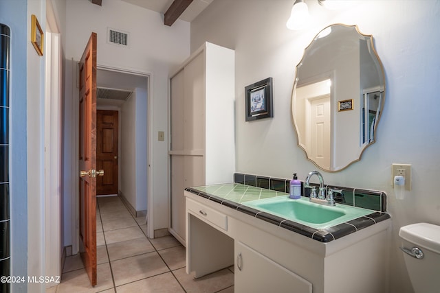 bathroom featuring tile patterned flooring, vanity, and toilet