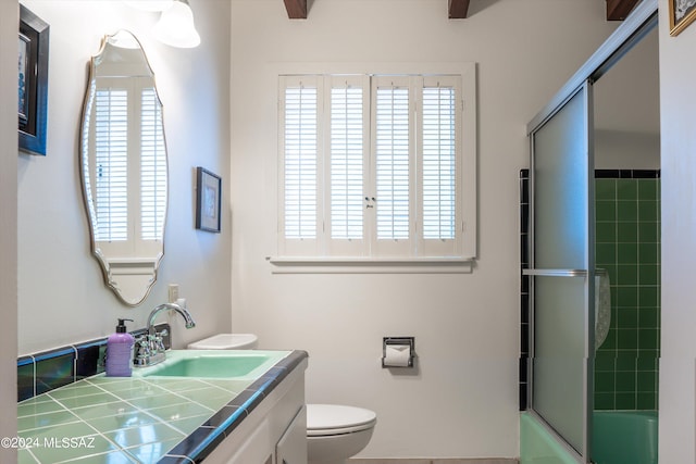 full bathroom featuring vanity, toilet, combined bath / shower with glass door, and a healthy amount of sunlight