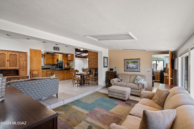 living room featuring light tile patterned flooring and a textured ceiling