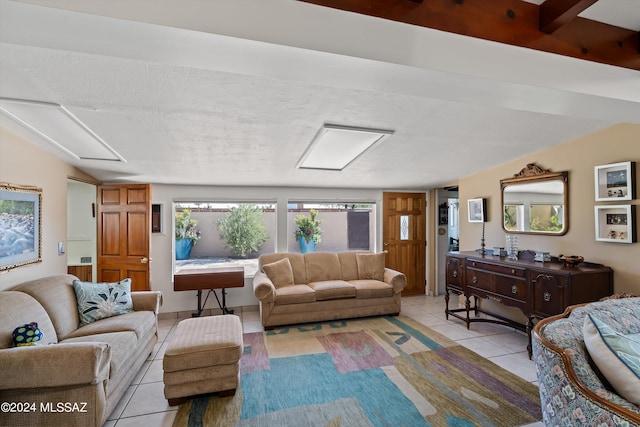 living room with vaulted ceiling and light tile patterned floors