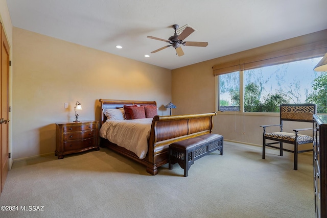 bedroom with light colored carpet and ceiling fan