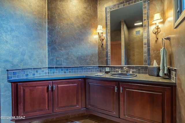 bathroom featuring vanity and backsplash